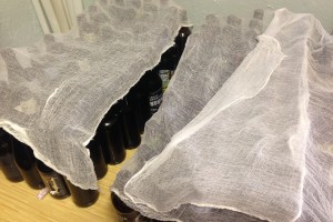 Bottles with cheese cloth on top
